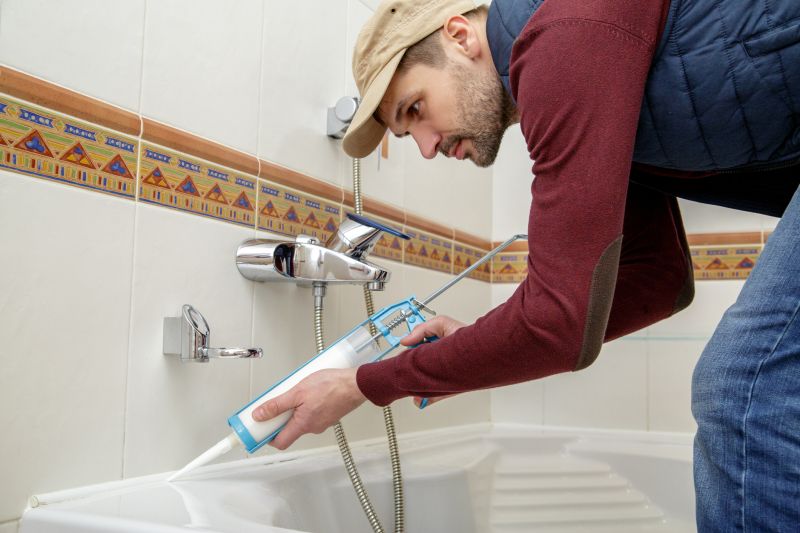 Professional preparing a bathtub for refinishing